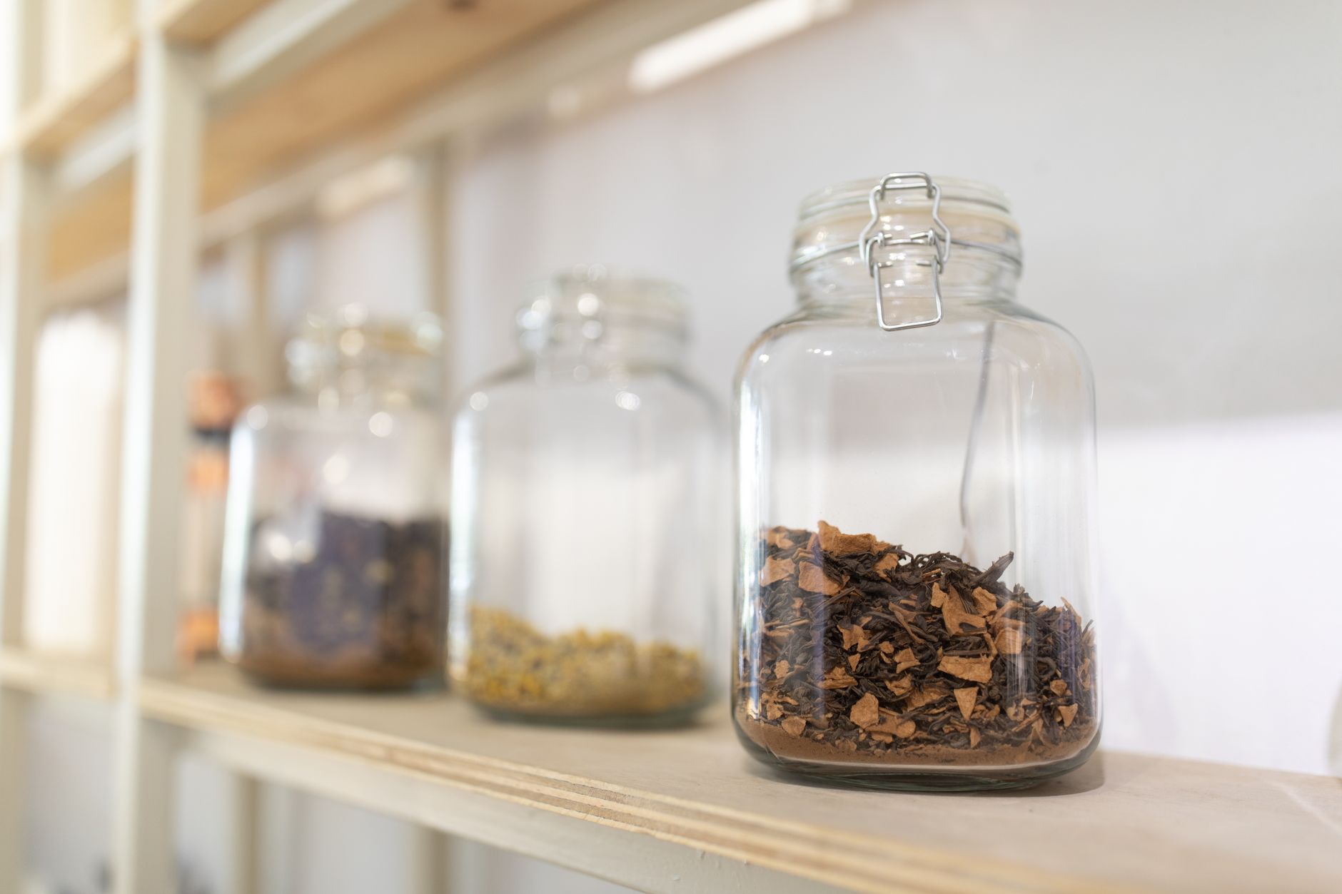 dried chaga chunks in a glass jar on a wooden table