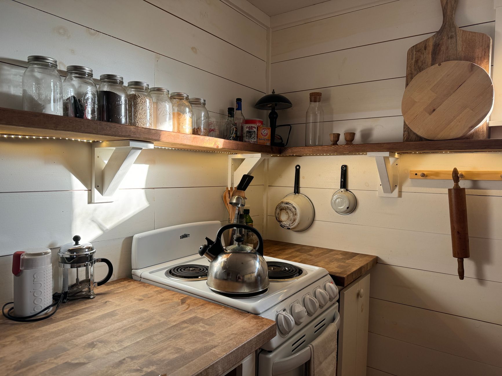 a pressure cooker full of quart mason jars on a kitchen stove