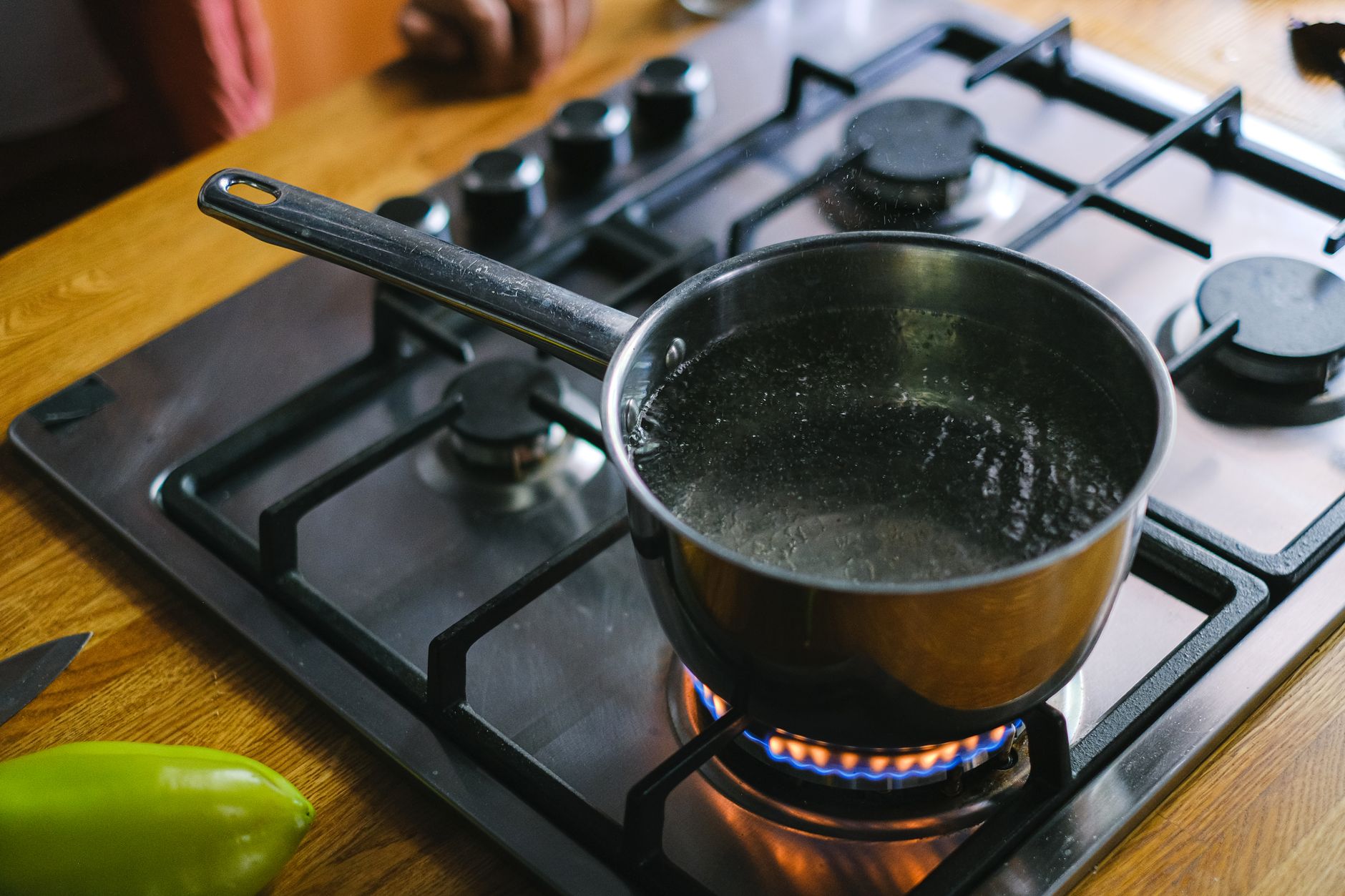 a large metal pot of steaming water on a propane burner