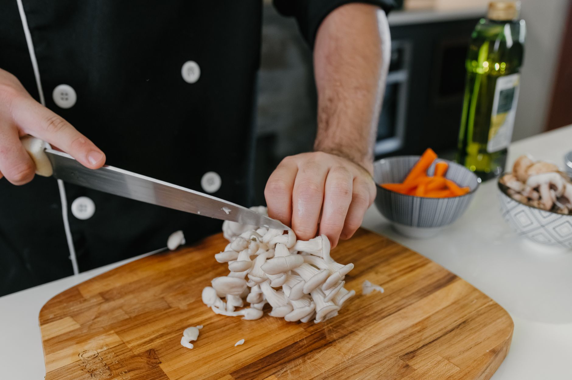 a white oyster mushroom grow kit sitting on a kitchen counter beside a spray bottle