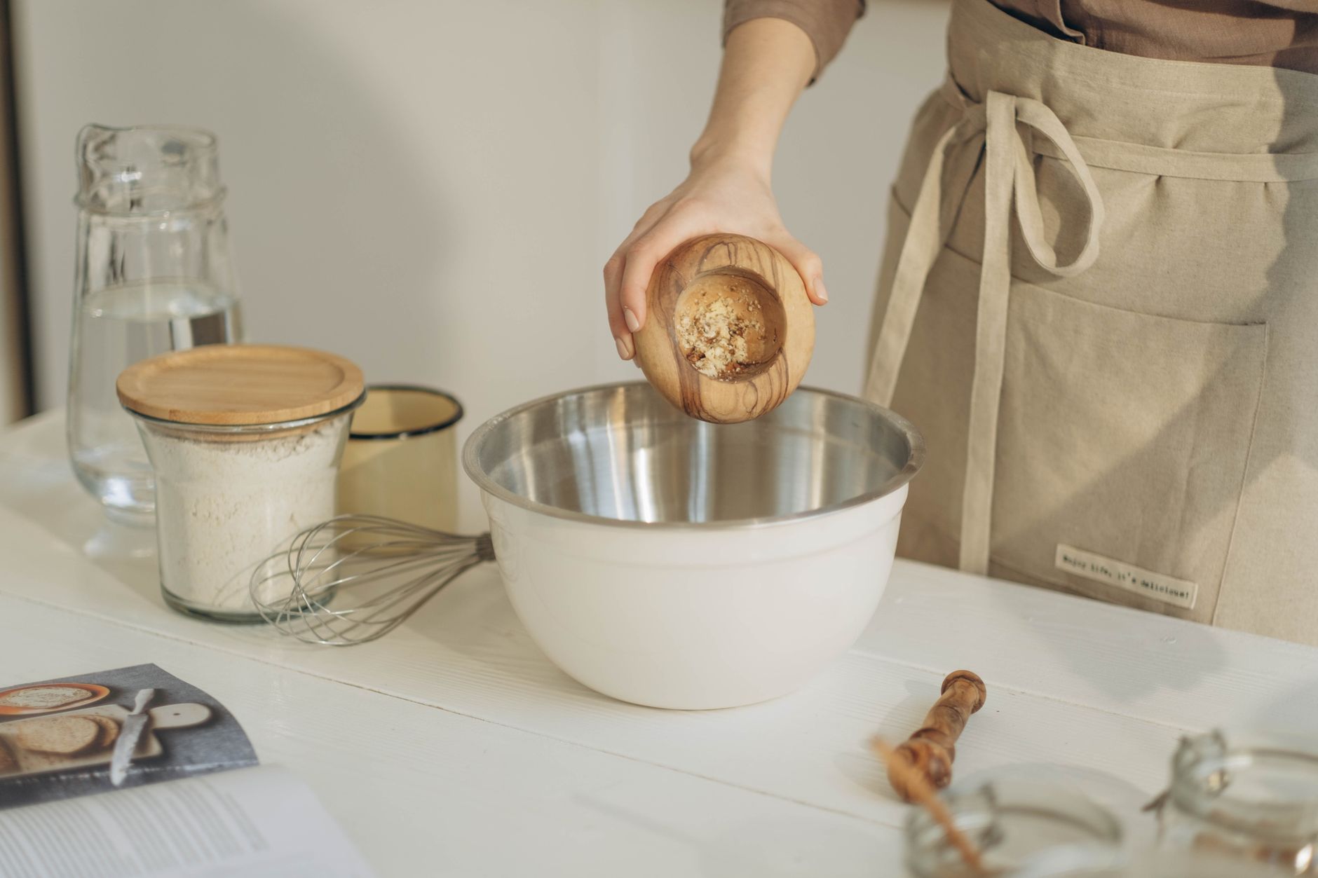 hands mixing hardwood sawdust and bran in a large bowl for mushroom substrate